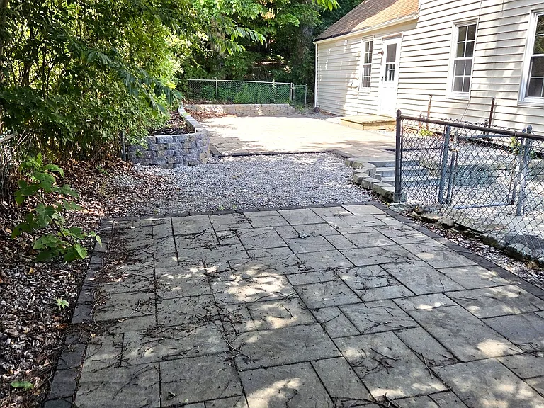 The first floor also enjoys a large private patio with flower beds and ample room for grilling.
