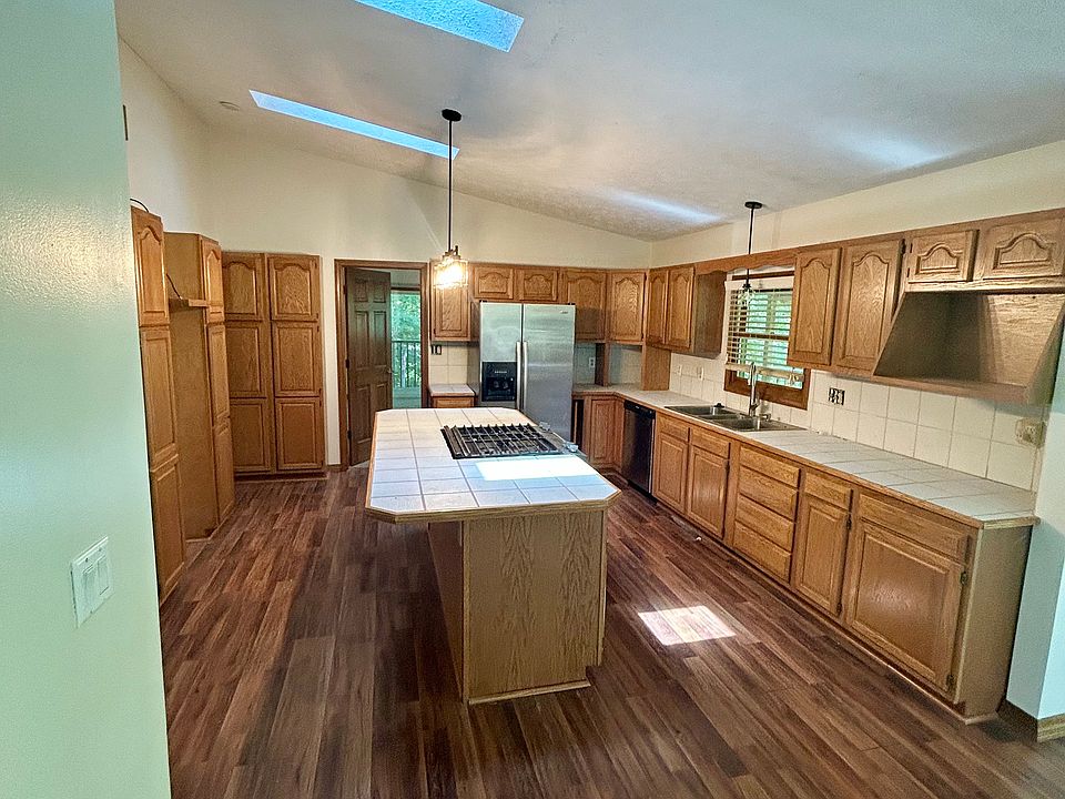 Tons of cabinet space in this kitchen, complete with island, gas range and stainless appliances.