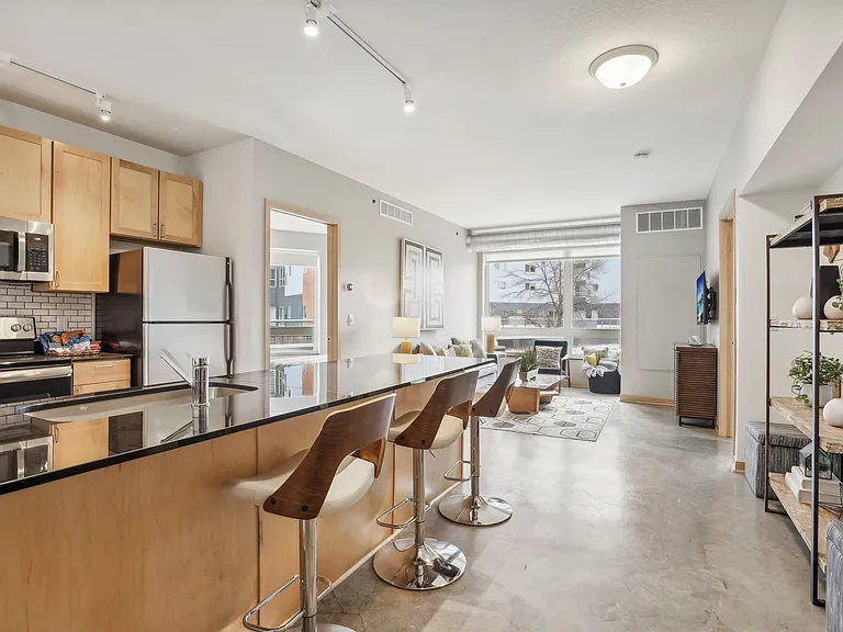 Experience elegance in this modern kitchen and living space, perfect for stylish urban living. Experience elegance in this modern kitchen and living space, perfect for stylish urban living.