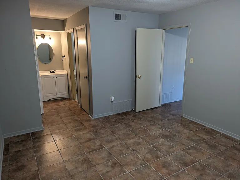 This is a view from the bedroom facing the dressing area. The open door goes into the living area.