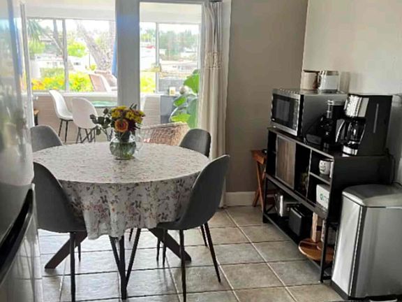 Dining room (seats 5 - 1 chair not shown), new microwave, new coffee maker, toaster, air fryer, blender, coffee grinder, tea kettle, etc.