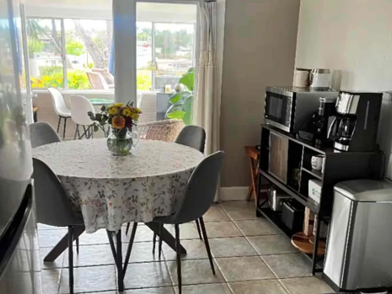 Dining room (seats 5 - 1 chair not shown), new microwave, new coffee maker, toaster, air fryer, blender, coffee grinder, tea kettle, etc.
