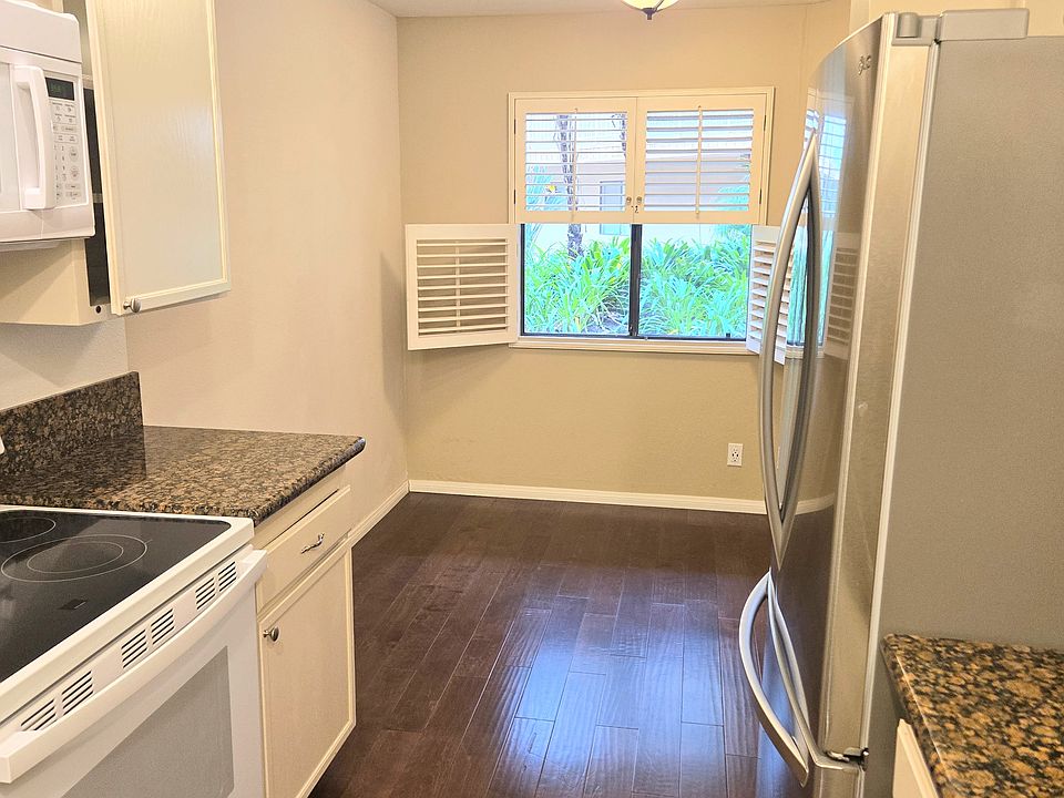 kitchen with view out to the courtyard with small dining area