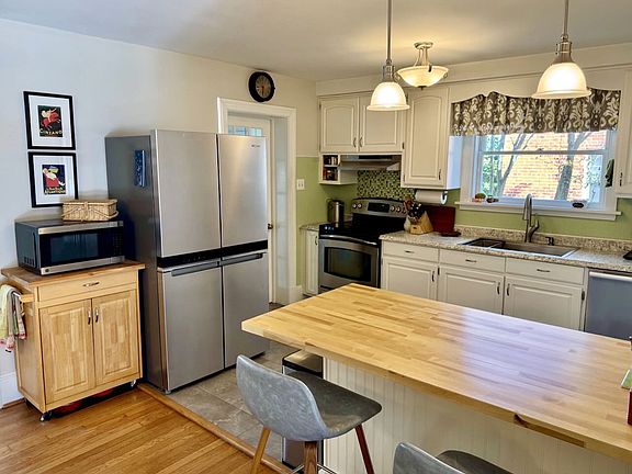 Laundry room off kitchen has ample storage