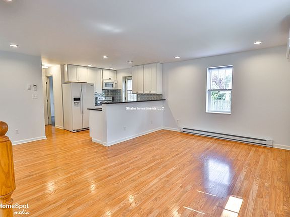 View of the great room and kitchen upon entering the house
