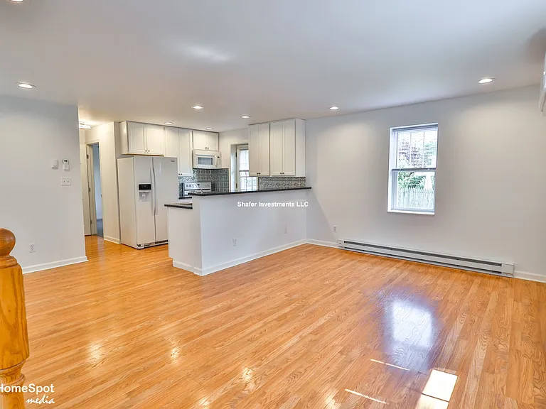 View of the great room and kitchen upon entering the house
