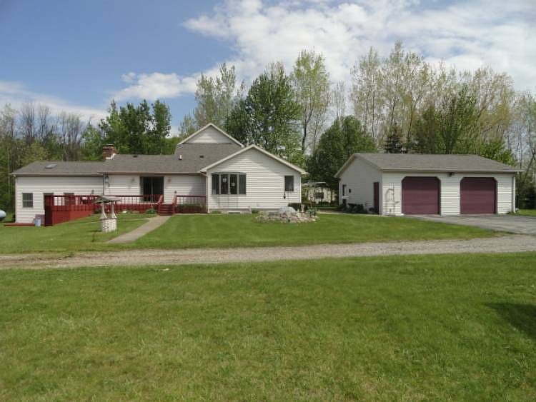 This 3364 square foot home rests on over 13 partly wooded acres and offers wonderful space both inside and out!  There's a possibility of 5 bedrooms and you won't believe how many could gather around the kitchen in this home!  It's truly unique and offers fun activities for all!  We'd love to have you give us a call and make this YOUR NEW HOME!