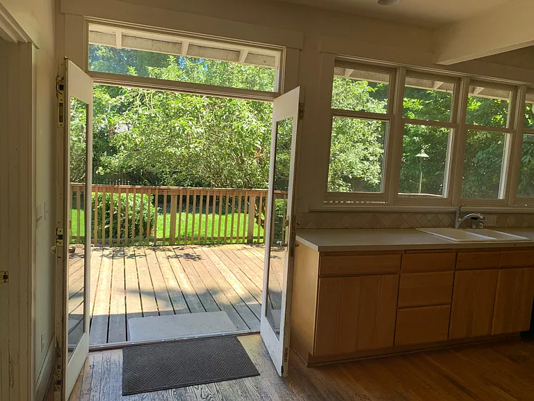 Portion of large new kitchen opening on to deck and back yard and gardens