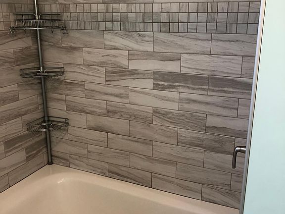 Oversized soaking tub with beautifully tiled shower.