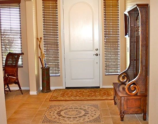 Front Entry area with 12 inch tile flooring and crown molding