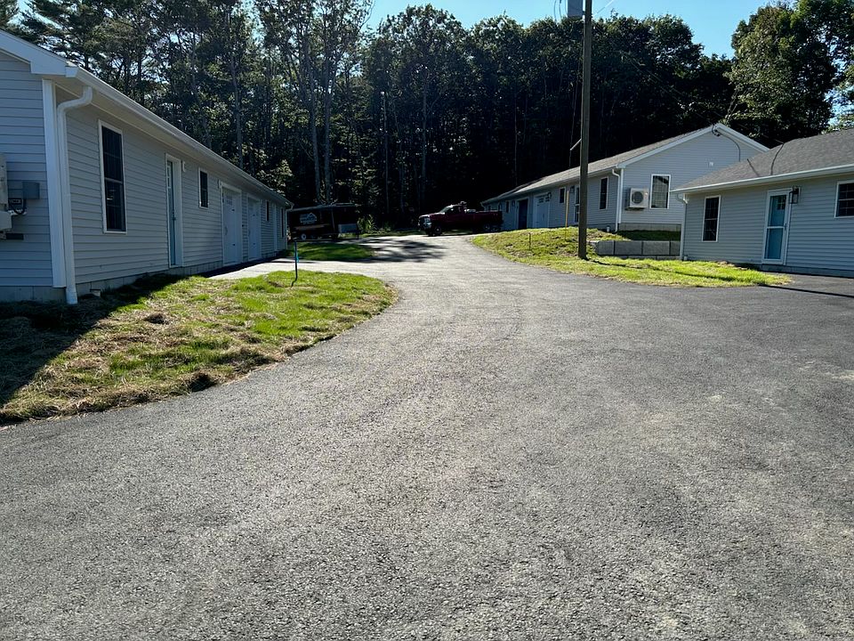 paved driveway leading to the units
