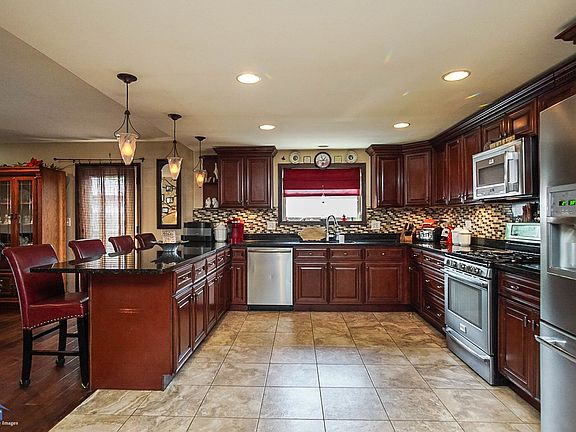 Dream Kitchen Highlights - cherry finish cabinets, granite countertops, travertine flooring and all stainless steel appliances. 