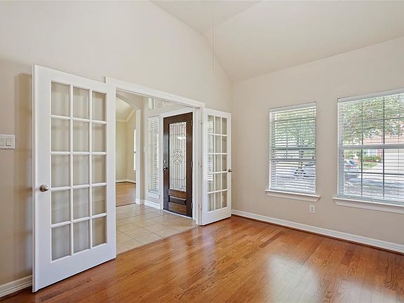 Private study with hardwoods, French Doors for privacy, custom built-ins and an oversized walk-in storage closet.