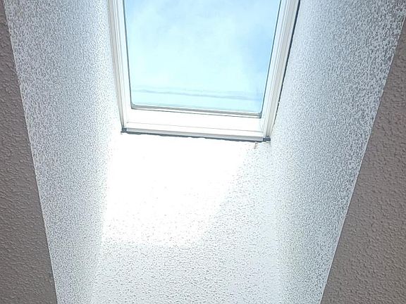 "Living room with skylights that fill the space with natural light."