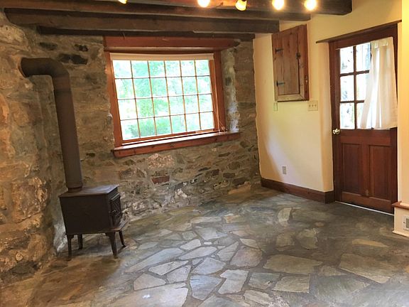 Breakfast room on the lower level features hand-hewn logs in