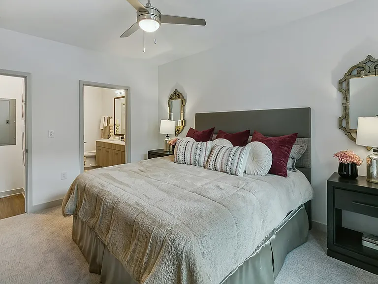 Enjoy a restful escape in this spacious bedroom.