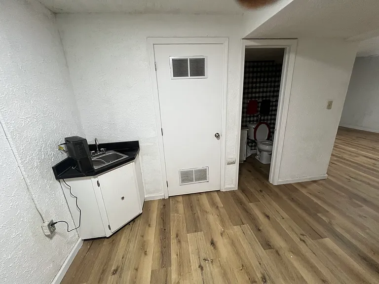 The shows the extra utility sink in the basement and half bath new Freshly painted new lighting