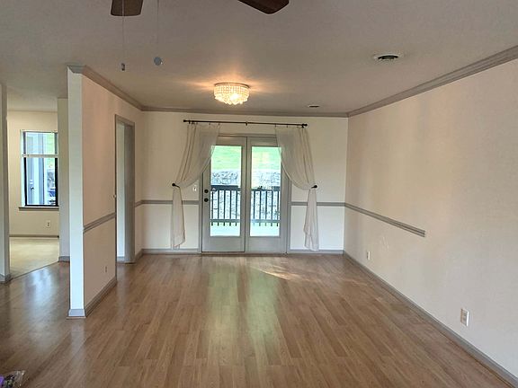 Open Living Room/ Dining room to deck. Kitchen entrance on left