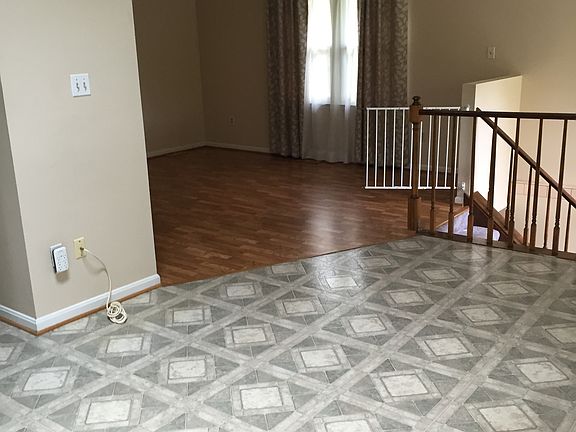 Bright, airy kitchen opens into living room. The kitchen ha