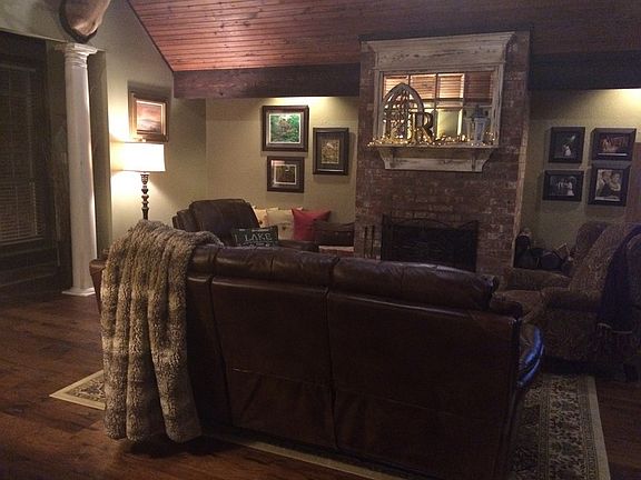 Living room with wood burning fireplace.