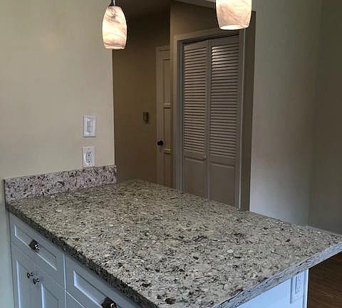 Kitchen countertops looking over at laundry area