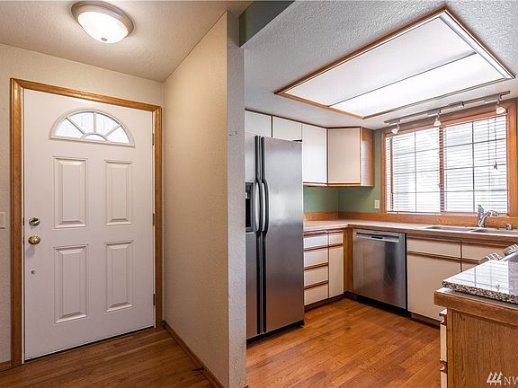 Entry and kitchen with hardwood floors