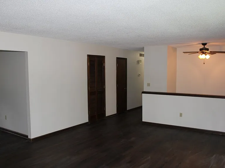 Hall way to 3 bedrooms 2 baths and access to downstairs.