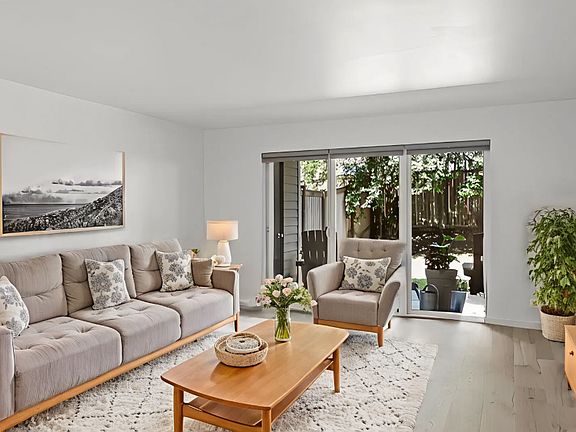 Living room looking out to back patio and fenced yard.
