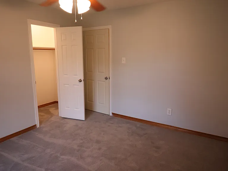 Bedroom #2 with ceiling fan and walk-in closet.