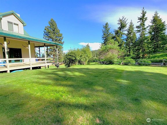 Covered parking provided with side entrance to the house.  Metal roof built to last the years.>