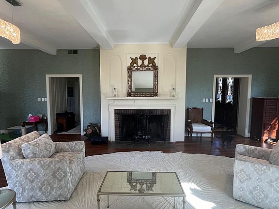 Formal living room is the full-depth of the house. Incredible detail and calming symmetry.