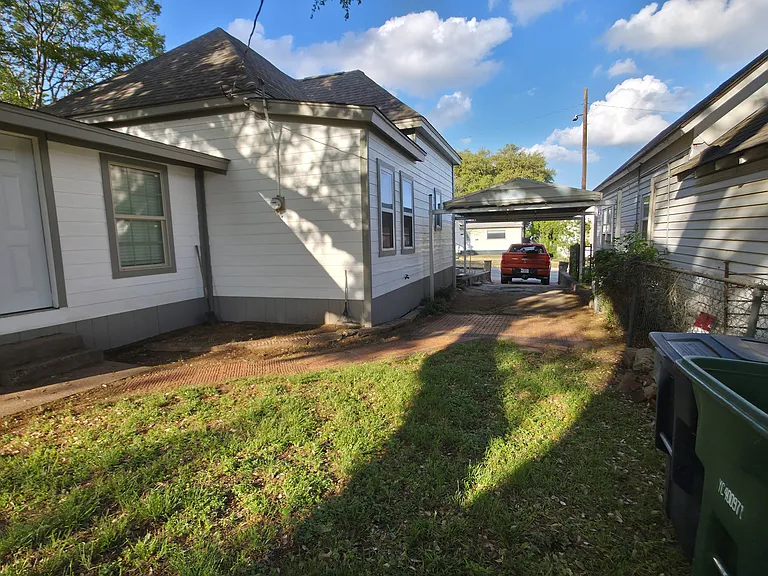 spacious backyard with beautiful live oak tree with plenty of shade and concrete patio