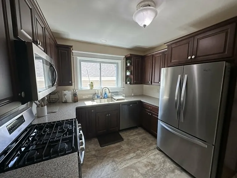Additional kitchen view showcasing generous counter space and a bright, functional layout.