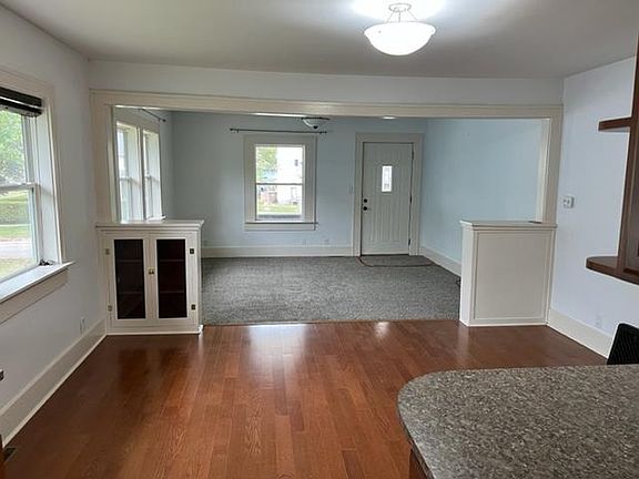 View from kitchen of dining area and living room. New carpet in living room and freshly painted.