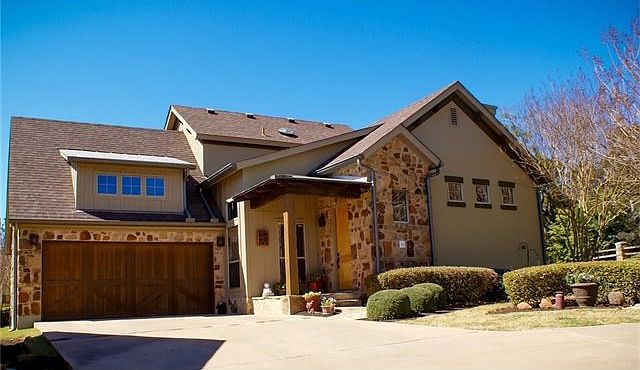 Surrounded by mature trees and beautiful hills. The 2-car garage enters in the laundry room and an extra parking pad is off the driveway. Plenty of storage space and 2 built in floor-to-ceiling wood shelf racks.