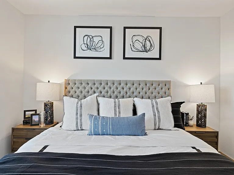 Recharge in this cozy, modern bedroom with calm tones and style.