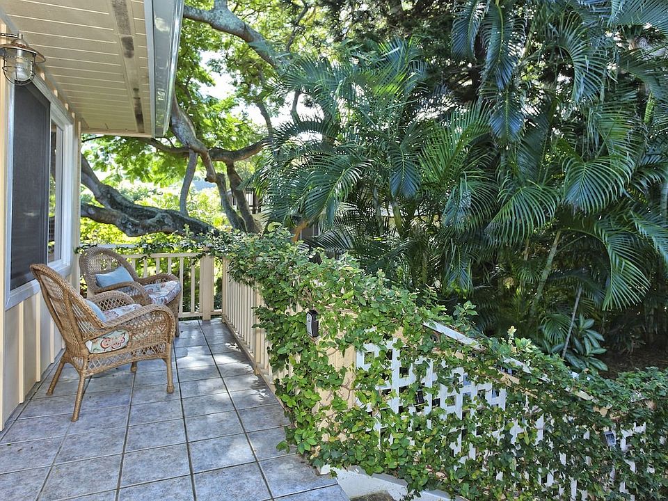 front porch, shaded by a magnificent monkey pod tree