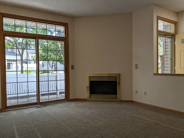 The main level has an open floor plan with large windows and a gas fireplace