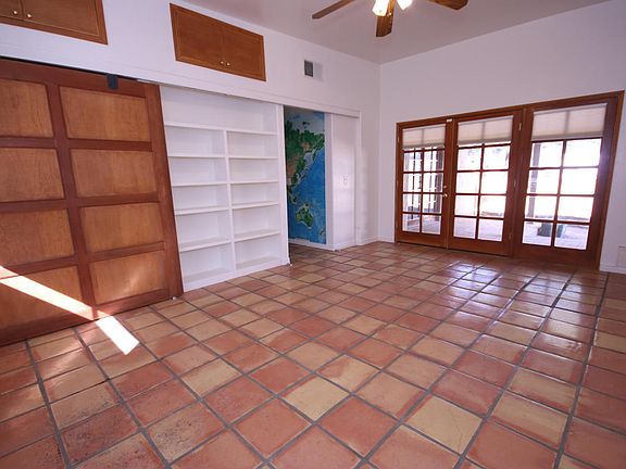 Den opens to garage/ garden