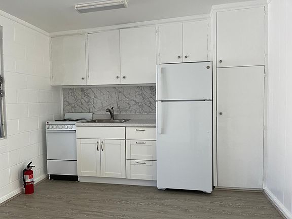 Completely renovated kitchen with new counters, sink, stove and refrigerator