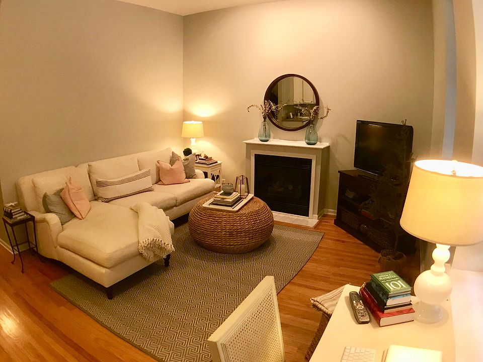 Living room, 10-foot ceilings, fireplace, hardwood floors throughout.