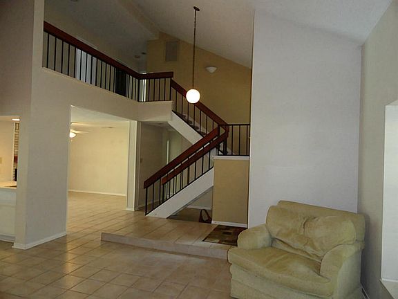 A glimpse of the entry and stairs leading to the second floor.