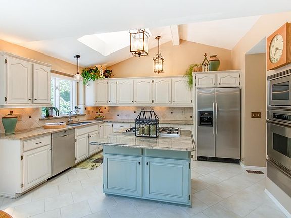 Updated kitchen/breakfast area with granite ,ss appliances, ceramic tile, sky light and a walk out to the beautiful deck.