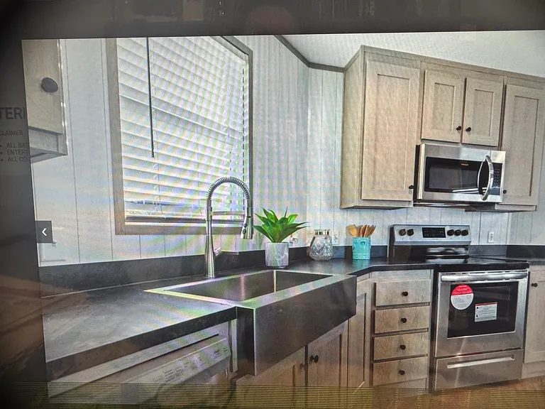 Close up kitchen farmhouse sink, oven, microwave, great storage!