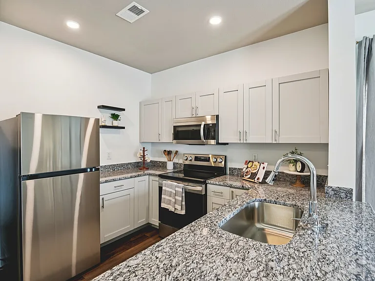 Experience the perfect blend of style and function in this bright, modern kitchen featuring premium granite countertops and sleek stainless steel finishes.