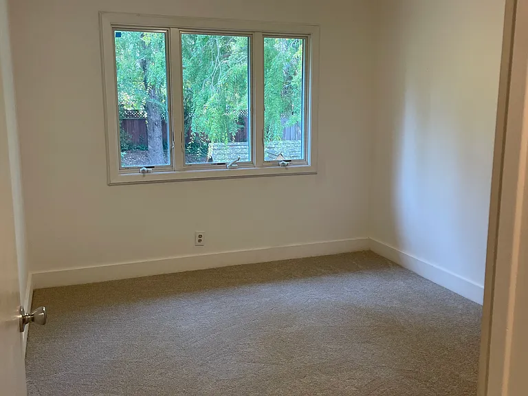 Bedroom with views of the rear yard