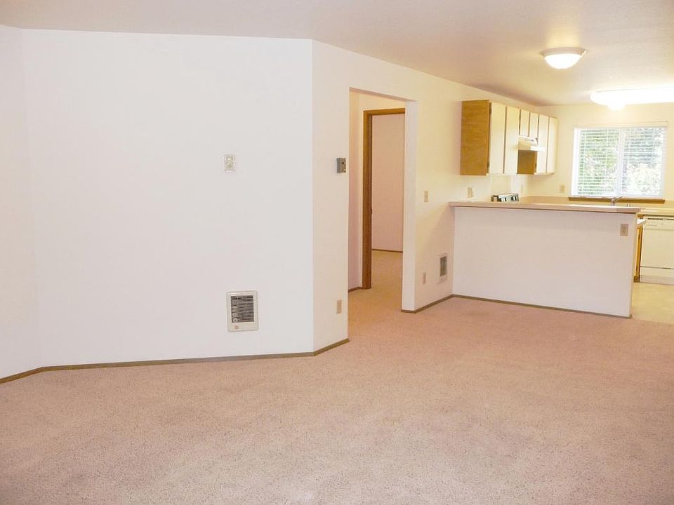 From large living room toward kitchen and hall toward master