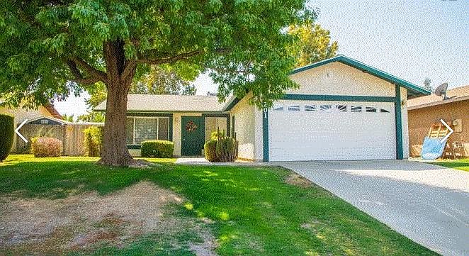Nice maintained front yard with entry to two car garage.