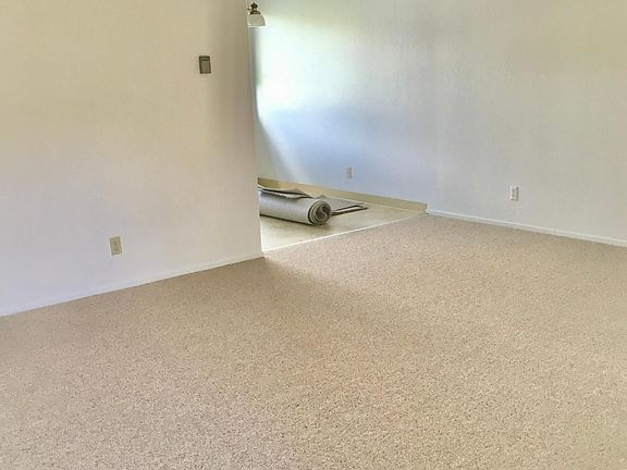 View upon entering the unit, looking at living room and entrance to eat-in kitchen