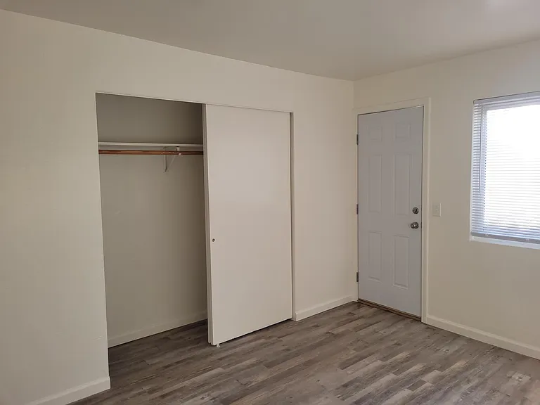 Bedroom 2 - closet and door to backyard.
